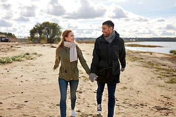 Image showing couple walking along autumn beach