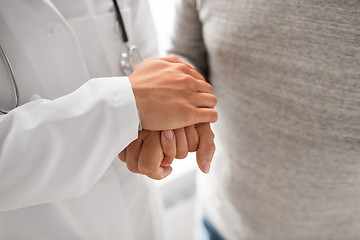 Image showing close up of doctor holding senior patient hand