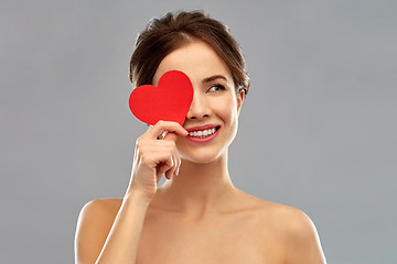 Image showing beautiful smiling woman holding red heart