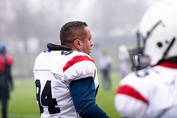 Image showing confident American football players leaving the field