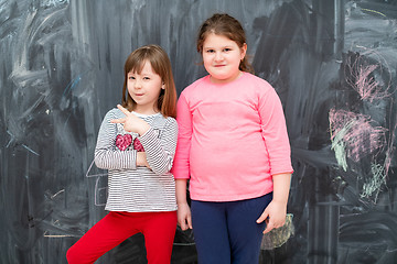 Image showing portrait of little girls in front of chalkboard