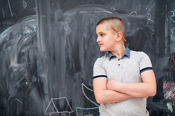 Image showing portrait of little boy in front of chalkboard