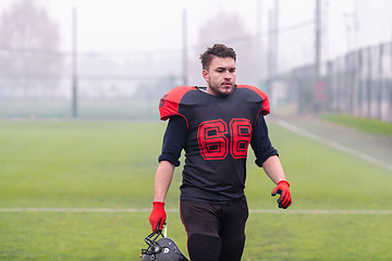 Image showing confident American football player leaving the field