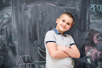 Image showing portrait of little boy in front of chalkboard