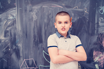 Image showing portrait of little boy in front of chalkboard