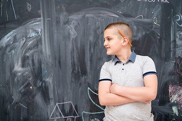 Image showing portrait of little boy in front of chalkboard