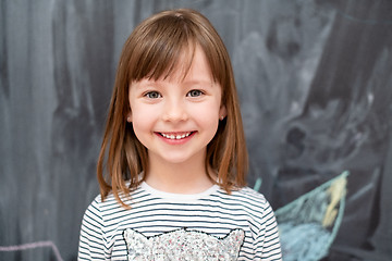 Image showing portrait of little girl in front of chalkboard