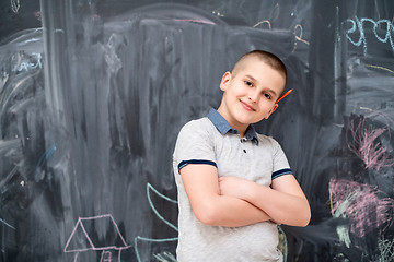 Image showing portrait of little boy in front of chalkboard