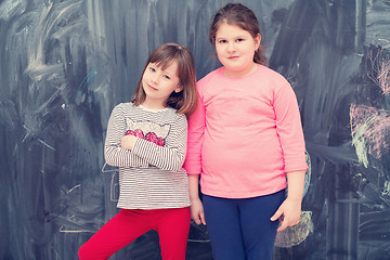 Image showing portrait of little girls in front of chalkboard