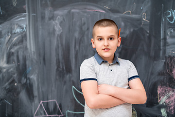 Image showing portrait of little boy in front of chalkboard