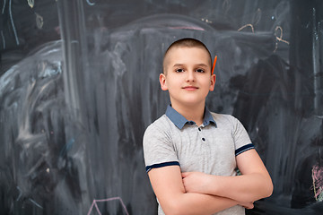 Image showing portrait of little boy in front of chalkboard