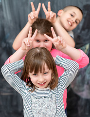 Image showing group of kids standing in front of chalkboard