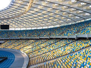 Image showing KYIV, UKRAINE - July 19, 2018. Panoramic view of construction of the stadium roof, tribunes with yellow and blue seats of NSC Olimpiysky.