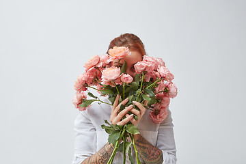 Image showing Bouquet of beautiful roses in the hands of a girl