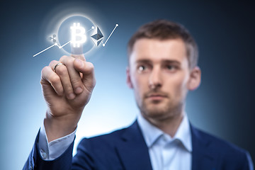 Image showing the man clicks Icon Bitcoin on virtual screen.