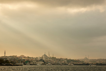 Image showing Panoramic view of the sunset in the rays of the sun on the dramatic rain sky of Istanbul, Turkey