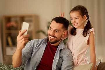 Image showing father and daughter taking selfie at home