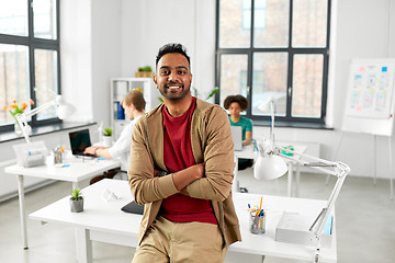 Image showing smiling indian man at office