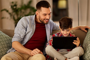 Image showing father and son with tablet pc playing at home