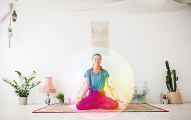 Image showing woman meditating in lotus pose at yoga studio