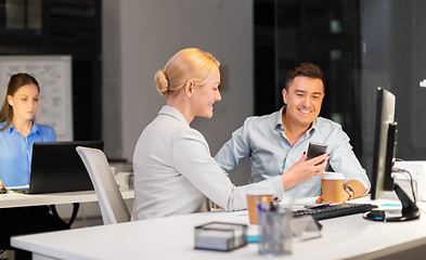 Image showing business people with smartphone at night office