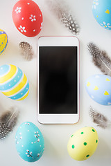 Image showing smartphone with easter eggs and feathers