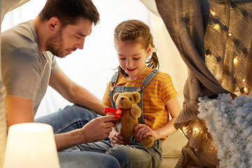 Image showing happy family playing with toy in kids tent at home