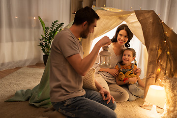 Image showing happy family playing in kids tent at night at home