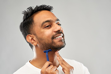 Image showing indian man shaving beard with razor blade