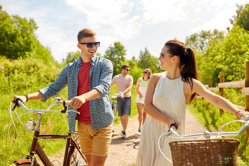 Image showing happy couple with bicycles at summer park