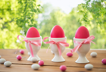 Image showing easter eggs in holders and candies on table