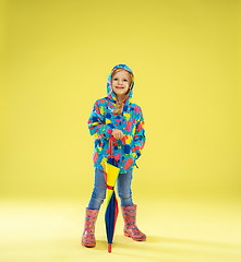 Image showing A full length portrait of a bright fashionable girl in a raincoat