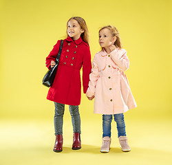 Image showing A full length portrait of a bright fashionable girls in a raincoat