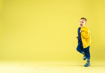 Image showing A full length portrait of a bright fashionable boy in a raincoat