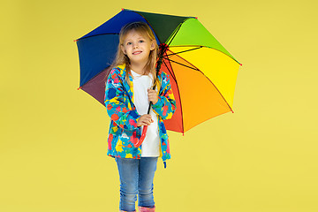 Image showing A full length portrait of a bright fashionable girl in a raincoat