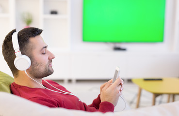 Image showing man enjoying music through headphones