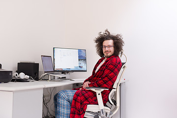 Image showing graphic designer in bathrobe working at home