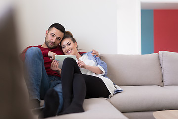 Image showing couple relaxing at  home with tablet computers