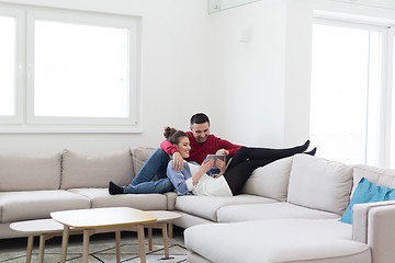 Image showing couple relaxing at  home with tablet computers