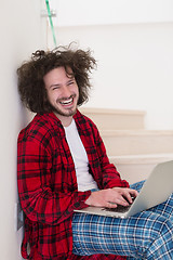 Image showing freelancer in bathrobe working from home