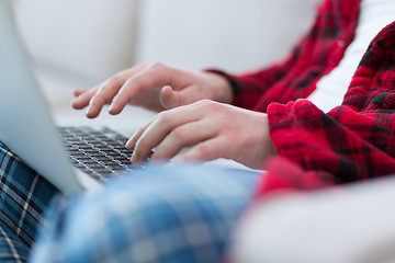 Image showing man freelancer in bathrobe working from home