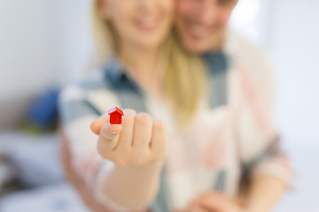 Image showing couple showing small red house in hands