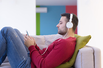 Image showing man enjoying music through headphones