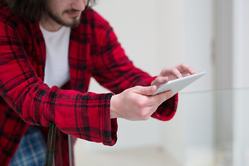 Image showing young freelancer using tablet computer