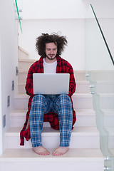 Image showing freelancer in bathrobe working from home