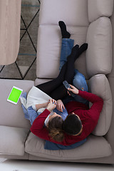 Image showing Young couple on the sofa watching television top view