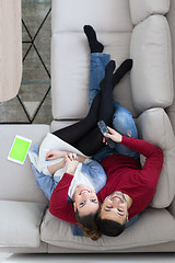 Image showing Young couple on the sofa watching television top view