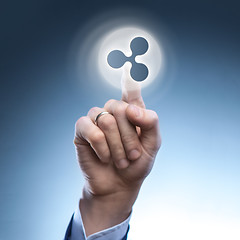 Image showing the hand of a man touches a ripple icon