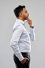 Image showing indian businessman side view over grey background