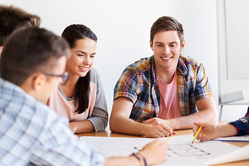 Image showing group of smiling students with blueprint